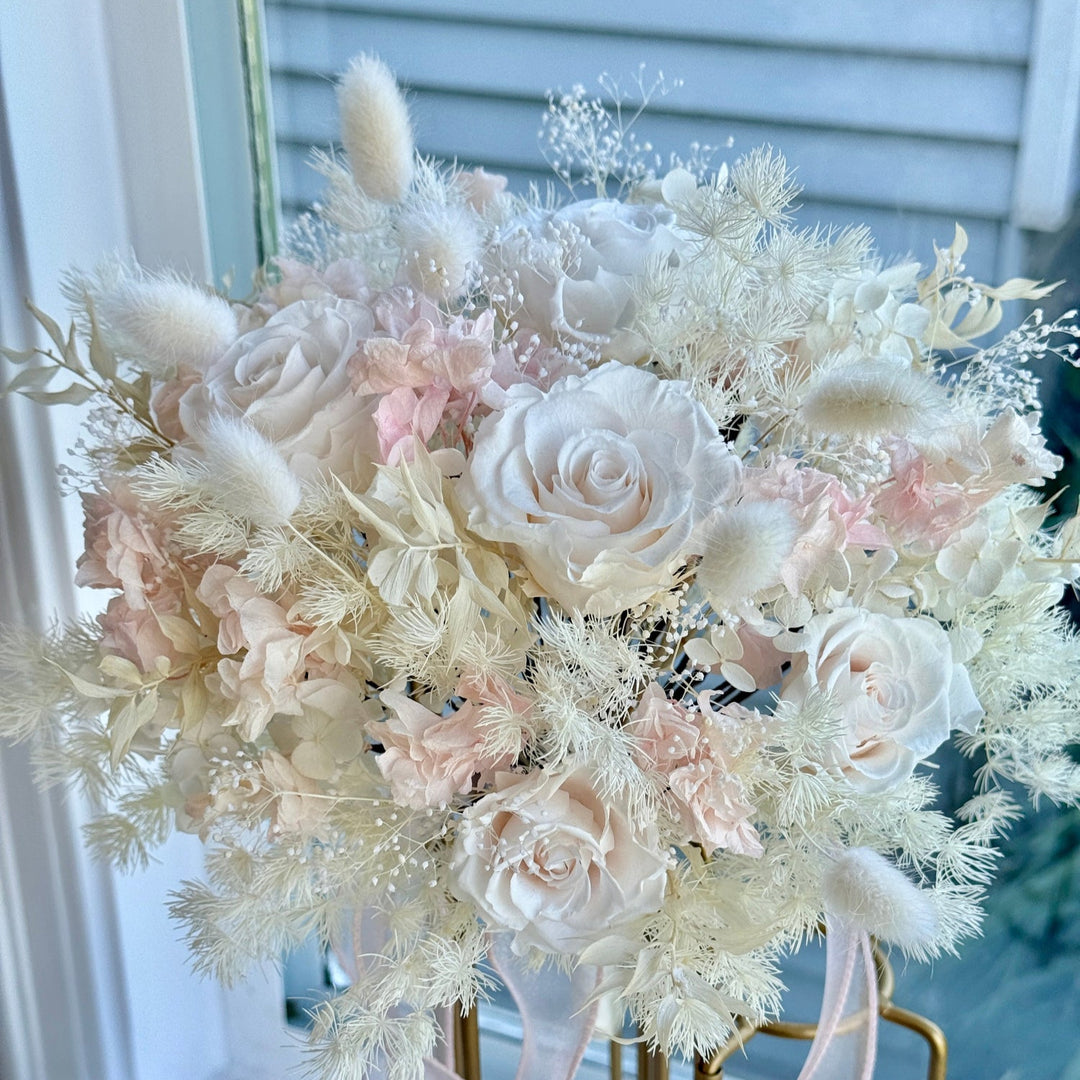 Close-up of preserved blush roses and hydrangeas in bridal bouquet. 