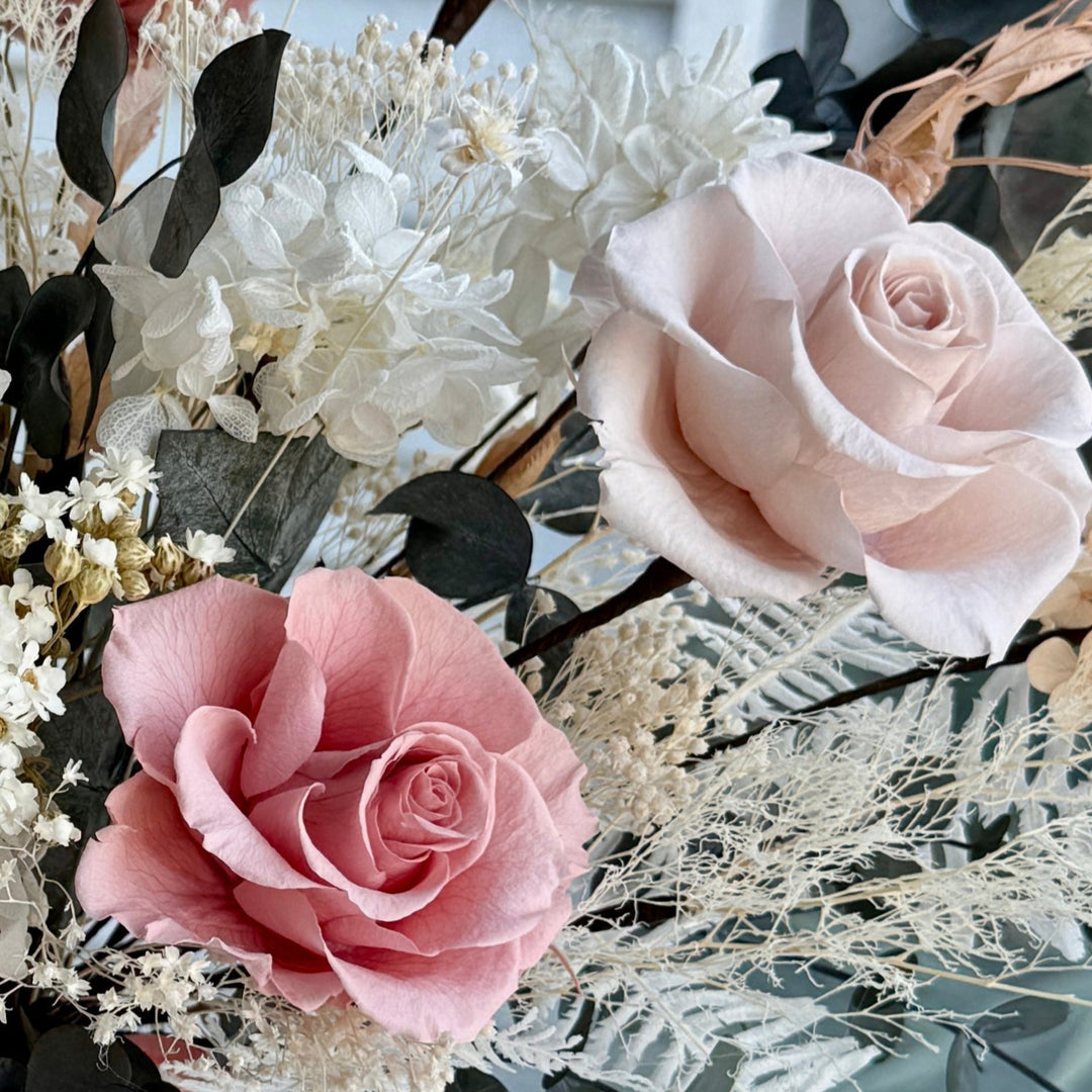 Close-up detail of blush pink preserved roses in a luxury bridal bouquet