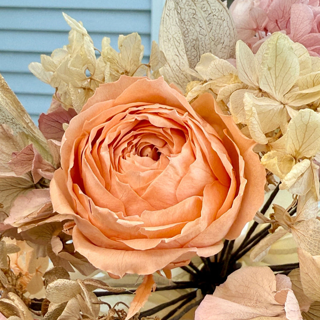 Close-up of preserved peach garden rose in romantic bridal bouquet