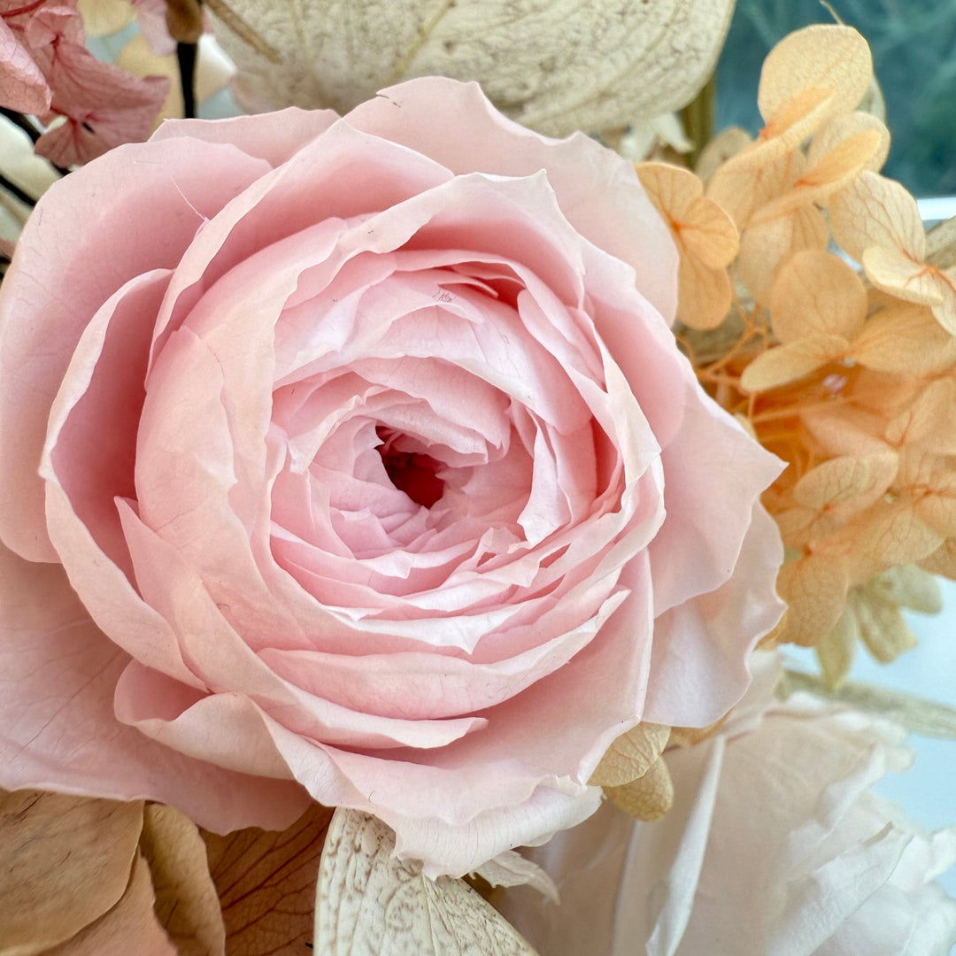 Close-up of preserved blush roses in bridal bouquet