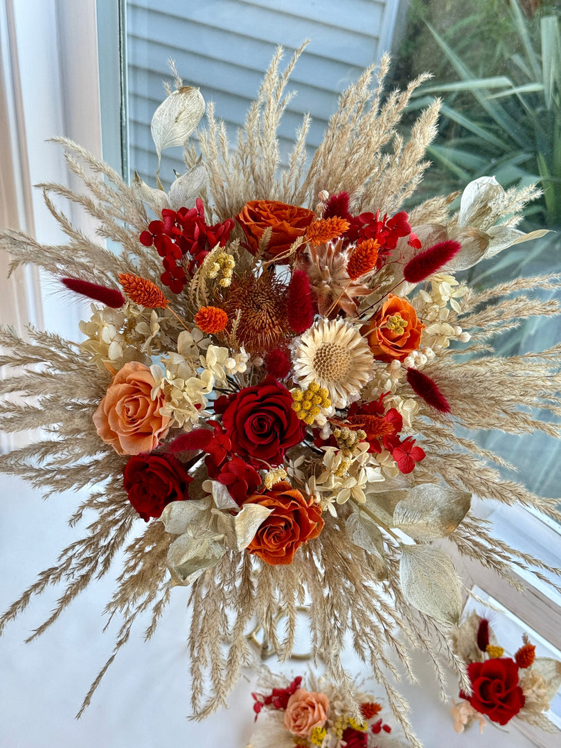 Handcrafted bohemian bridal bouquet featuring preserved roses, dried botanicals, and airy pampas grass
