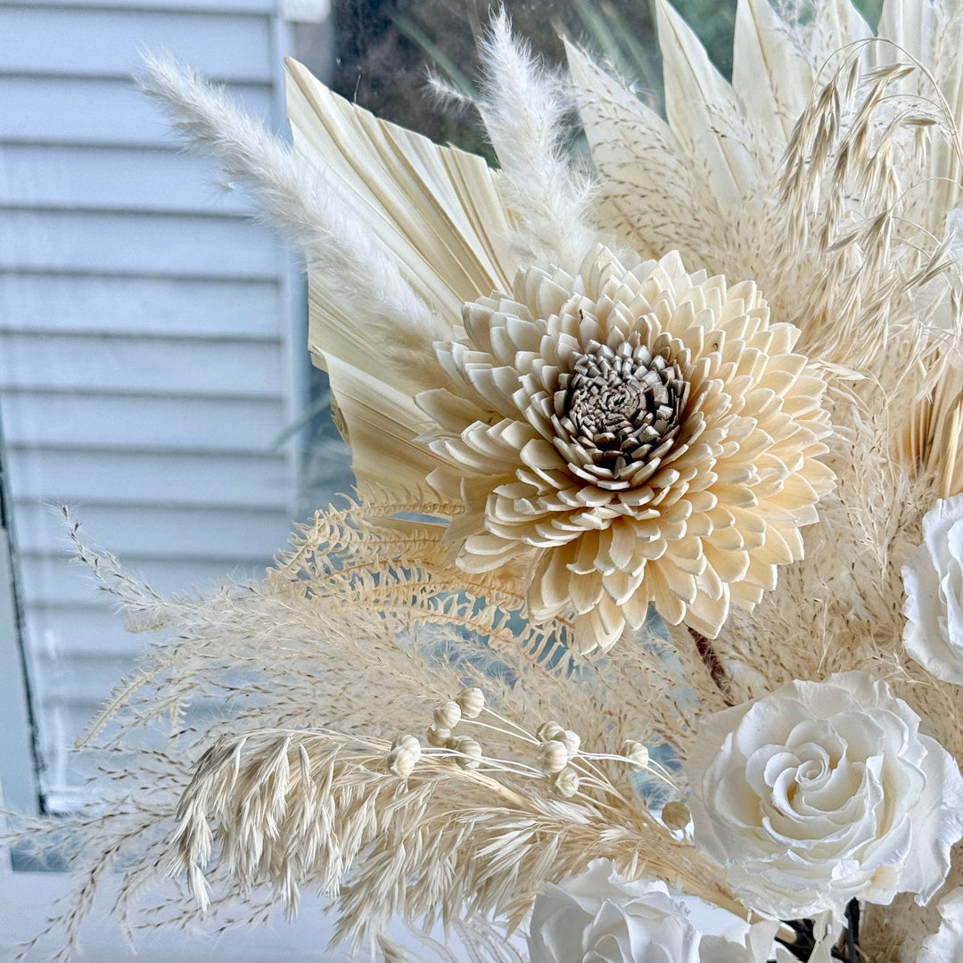 close-up of preserved ivory roses and sola flowers in bridal boquet