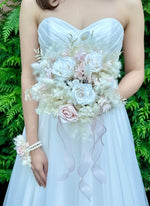 Load image into Gallery viewer, bride holding a preserved blush and ivory bridal bouquet in a romantic wedding style.