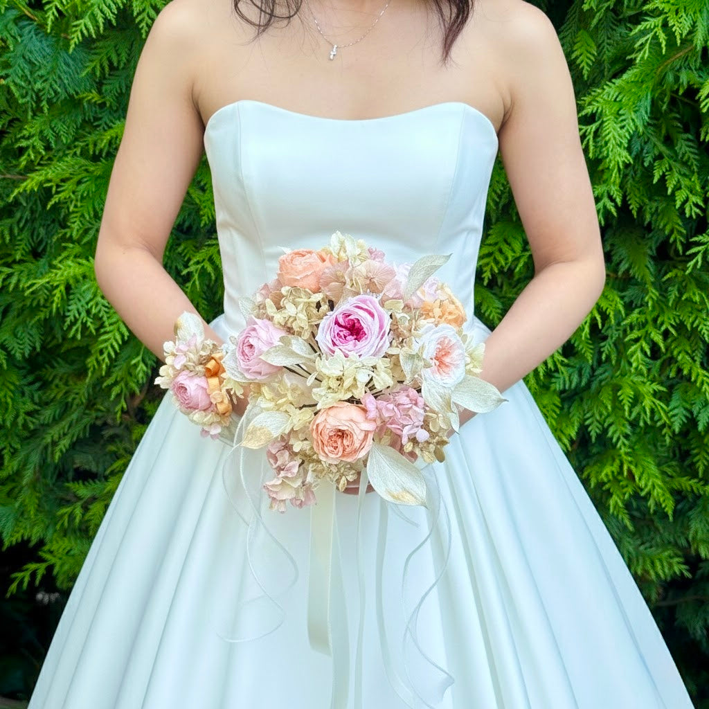 Bride holding a romantic preserved blush bridal bouquet in a soft garden wedding style