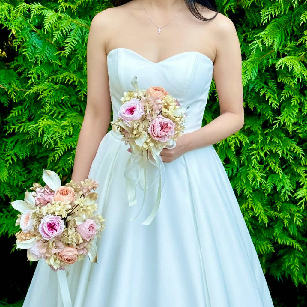 Bridesmaid holding a smaller preserved bouquet in blush and peach tones