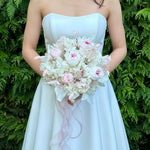 Load image into Gallery viewer, Bride holding a blushing garden rose preserved bridal bouquet in a white wedding dress