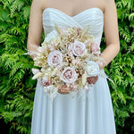 Load image into Gallery viewer, Bride holding a preserved nude blush bridal bouquet in a romantic wedding style