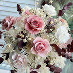 Load image into Gallery viewer, Close-up of blush pink preserved roses surrounded by ivory florals and textured foliage