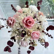Full view of blush pink preserved bridal bouquet with garden roses, ivory hydrangeas, and burgundy eucalyptus accents