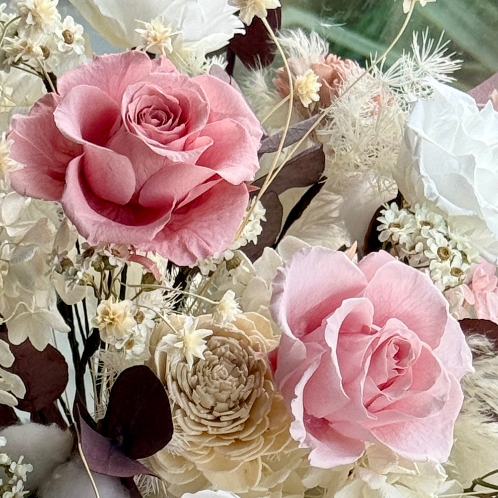 Close-up of blush garden rose with delicate preserved petals and neutral-toned florals